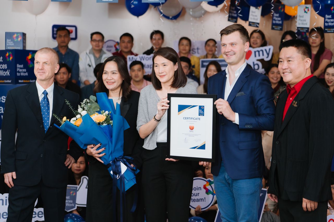 The WorkVenture team presenting a Best Places to Work™ certificate at a company office